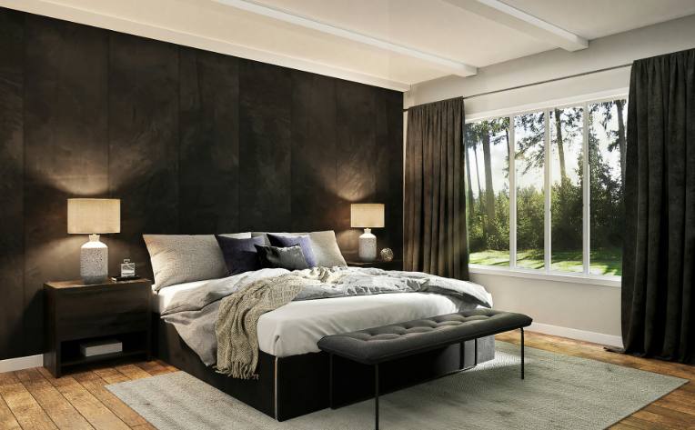 warm toned wood flooring in bedroom with grey area rug and monochromatic black walls and decor,